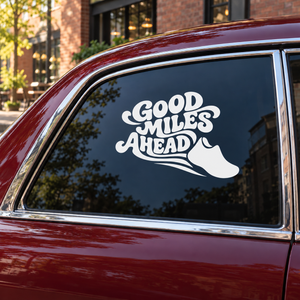 Vinyl decal with white “Good Miles Ahead” text and running shoe on car window
