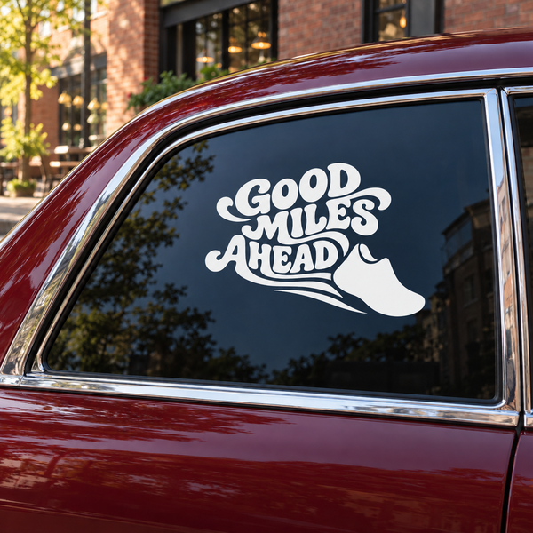 Vinyl decal with white “Good Miles Ahead” text and running shoe on car window