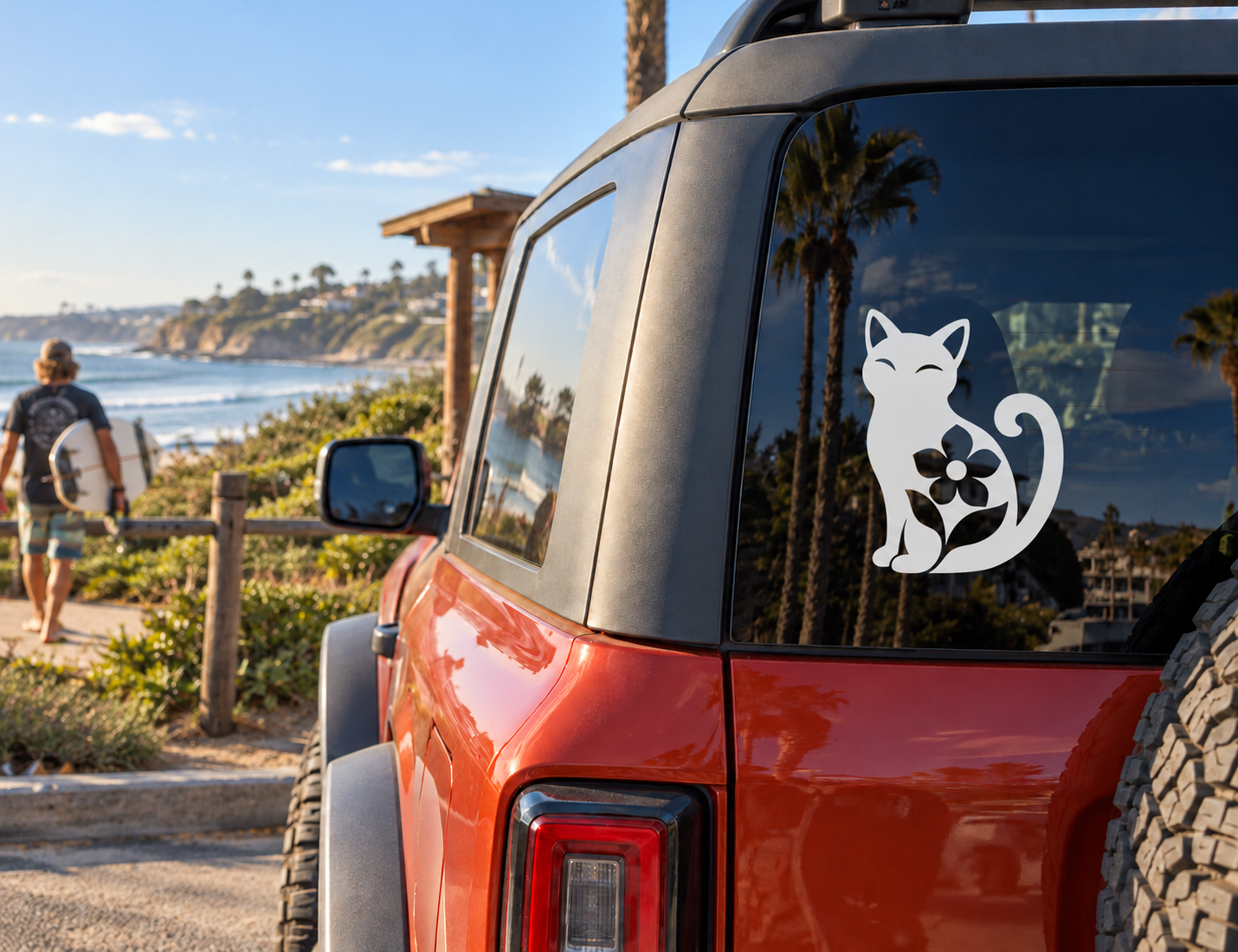 Black and white cat vinyl decal with flower on car window