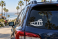 Vinyl decal of a pier silhouette with waves on a car rear window