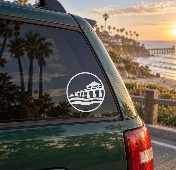 Circular vinyl decal with white pier-and-waves icon on a car window