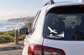 Black vinyl decal of a flying pelican on a car window