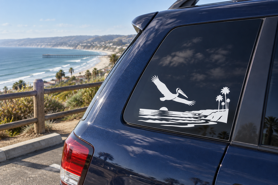Coastal pelican horizon vinyl decal on car window: white pelican over waves, palm trees, sun