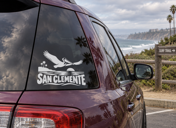 San Clemente pelican wordmark vinyl decal on car rear window, white graphic