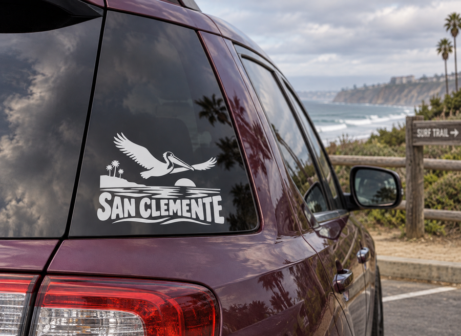 San Clemente pelican wordmark vinyl decal on car rear window, white graphic