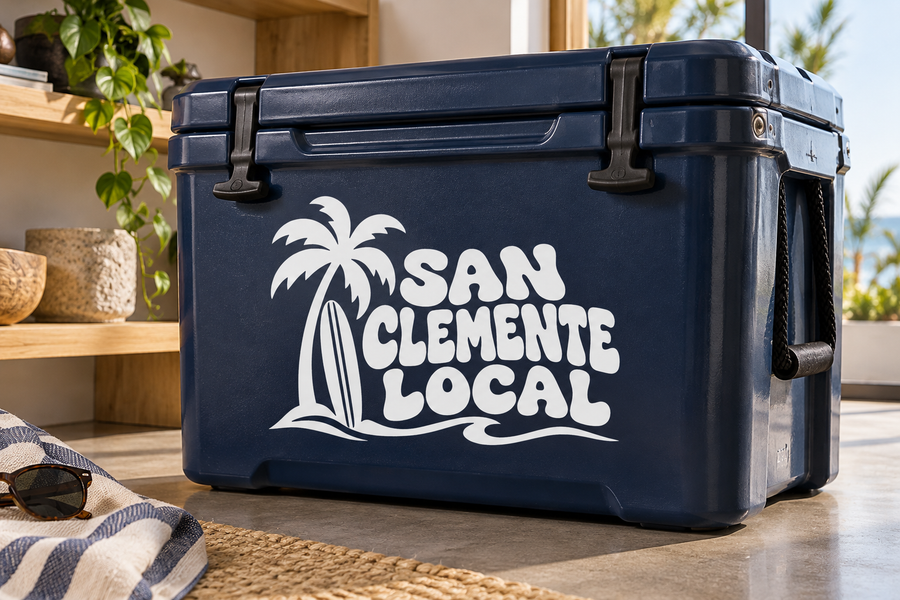 White palm tree and “San Clemente Local” vinyl decal logo on dark blue surface