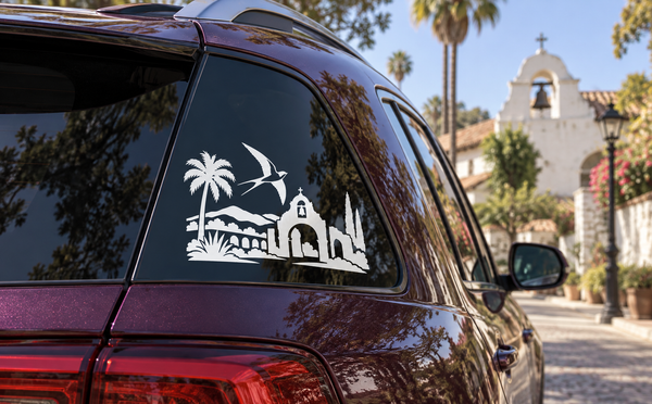 Car vinyl decal with black swallow over palm trees and arched mission horizon skyline