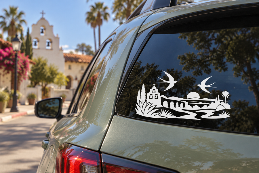 White vinyl decal of two swallow birds over mission and sunset horizon scene for windows
