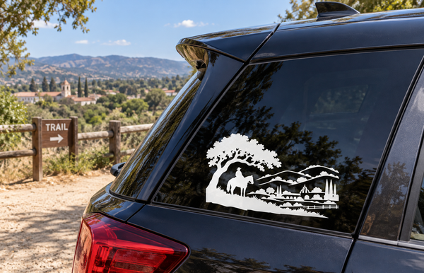 Vinyl car window decal with white desert landscape, rider on horse, and trees