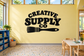 Black vinyl decal with 'CREATIVE SUPPLY CO' lettering and paint-roller icon
