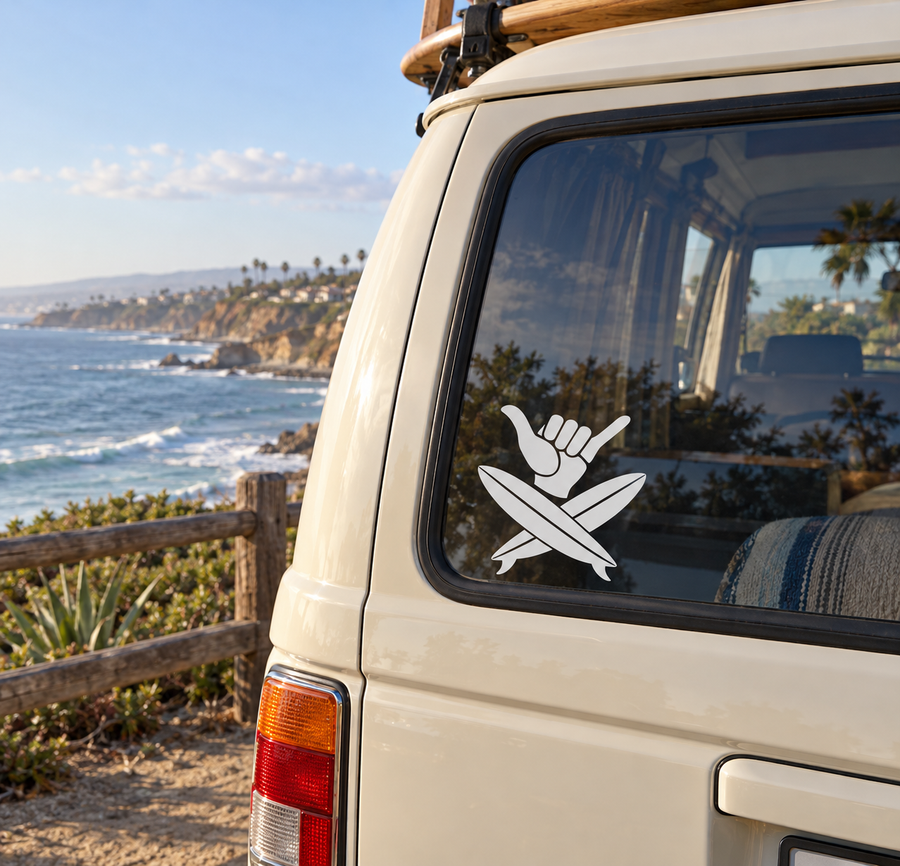Vinyl decal of crossed surfboards with shaka hand, white