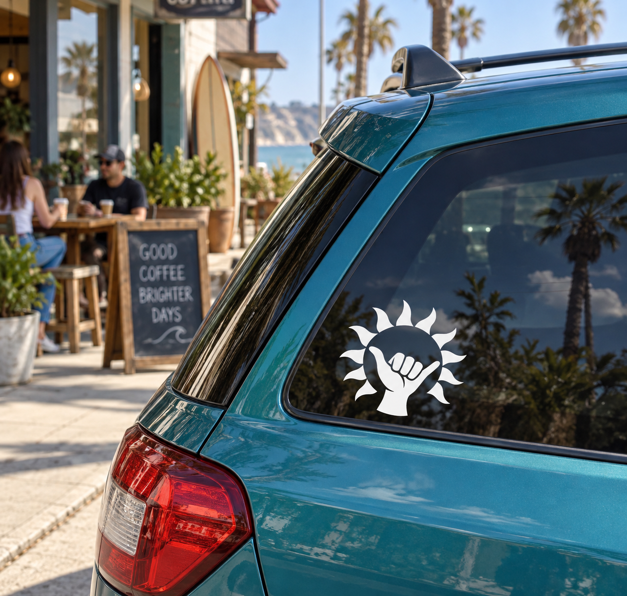 Sunshine shaka vinyl decal featuring a white sunburst with a black hand symbol on a car