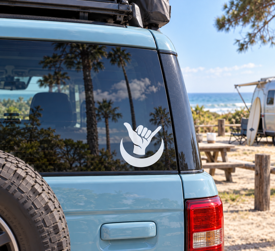 Crescent moon shaka vinyl decal on car window, white hand graphic