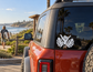 Black shaka hand vinyl decal with tropical leaf shapes on car window