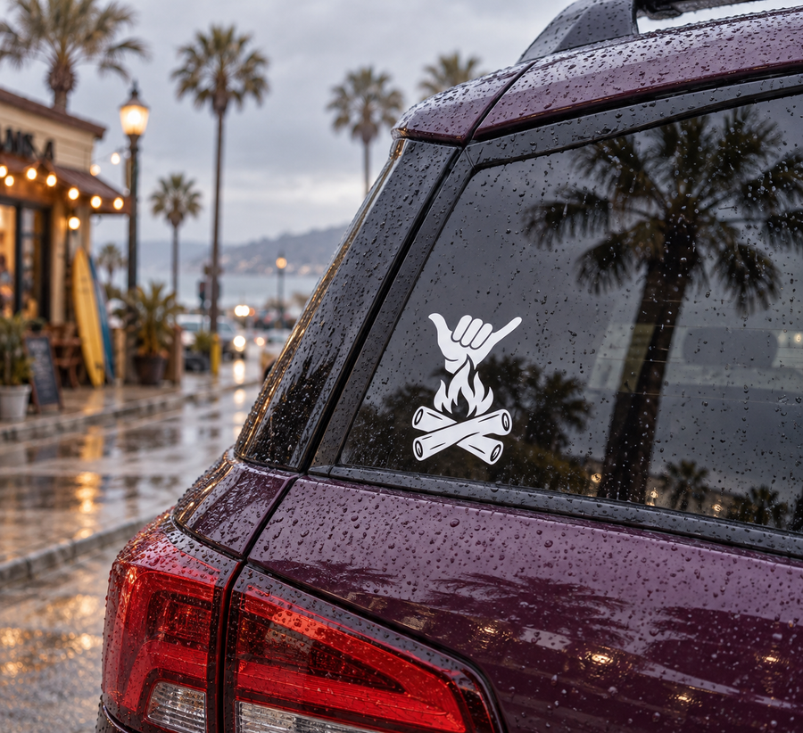 Campfire Shaka vinyl decal with white shaka hand above campfire on car window