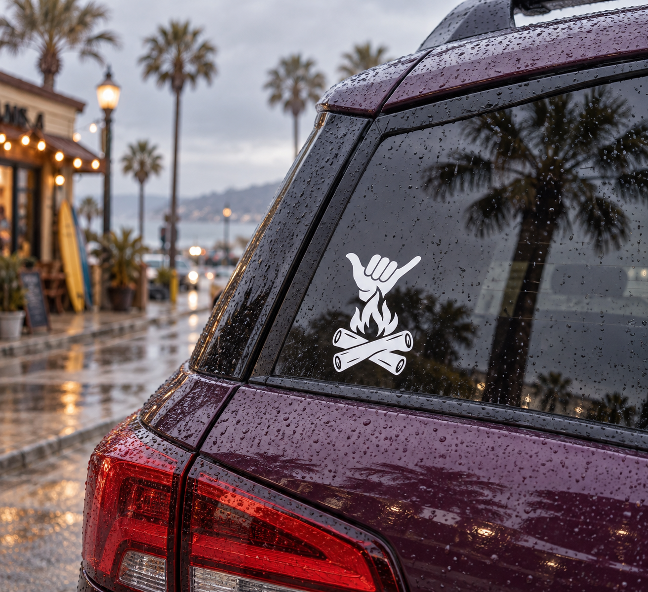 Campfire Shaka vinyl decal with white shaka hand above campfire on car window
