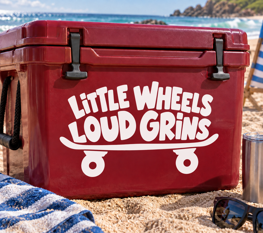 Skateboarding vinyl decal with white “Little Wheels Loud Grins” text and skateboard wheels