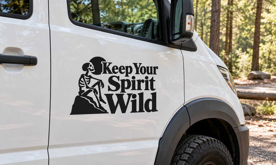 Black vinyl decal: seated skeleton and 'Keep Your Spirit Wild' text on car panel