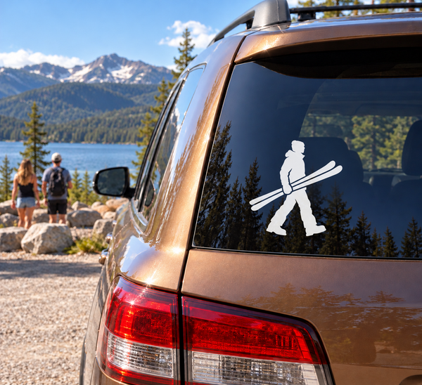 Skiing vinyl decal of a person walking with skis on a car window