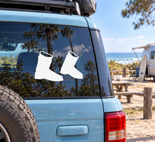 Vinyl decal of a pair of ski boots on a vehicle window