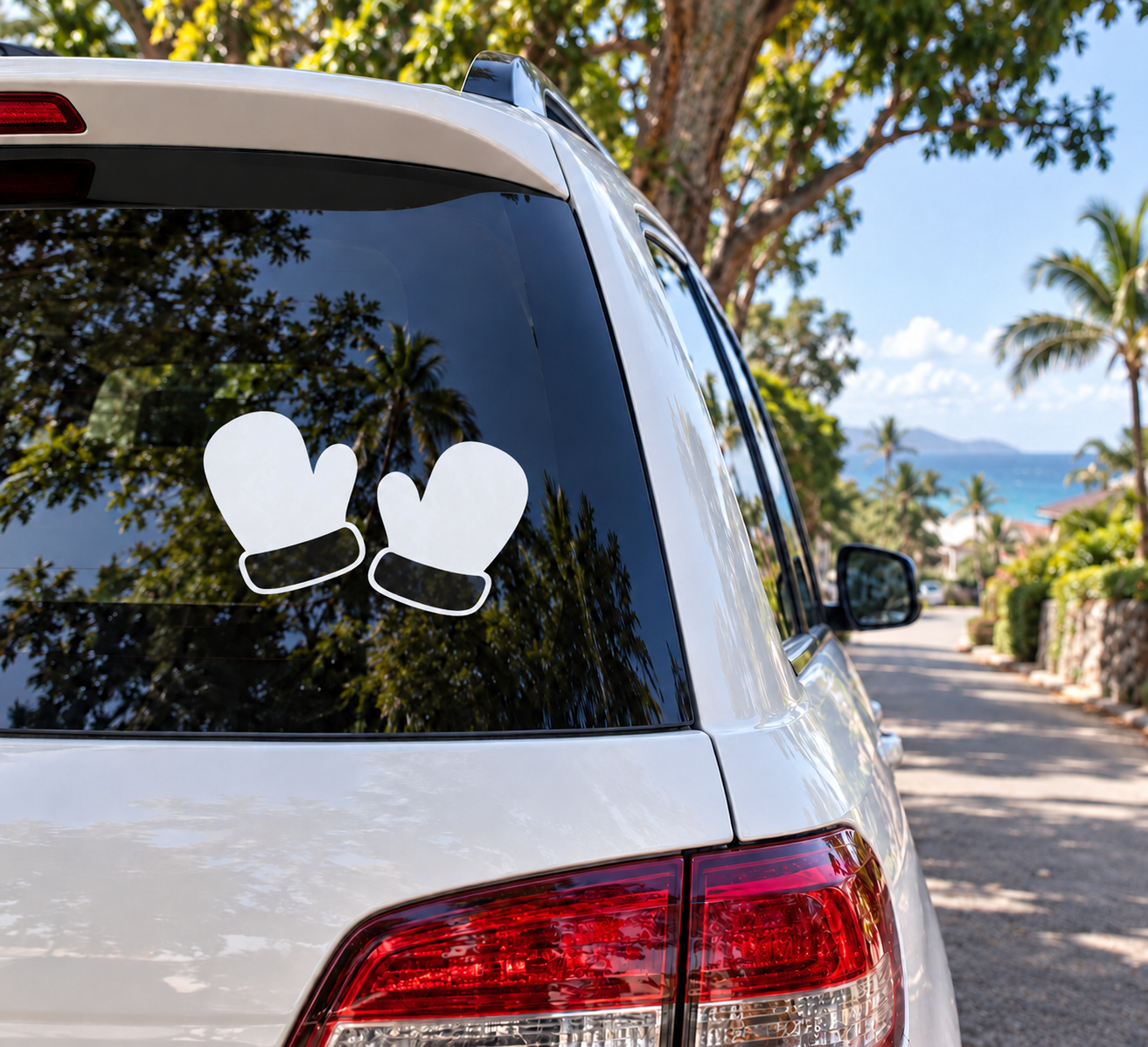 Vinyl mitten decal pair on car rear window, white mittens with dark palm details
