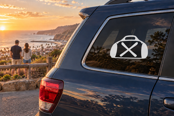 Vinyl decal of a ski gear bag with X logo on a car window