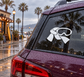Ski goggles vinyl decal in white and black on dark car glass.