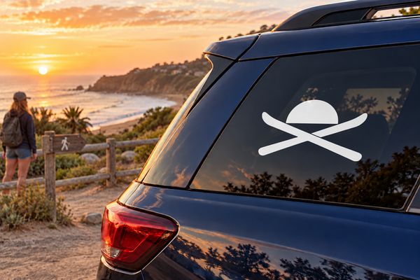 Skiing vinyl car decal with crossed skis and a sun icon on a rear window