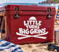 Vinyl decal with white "LITTLE TURNS BIG GRINS" and ski icon on red