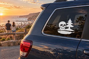 Skull and pine horizon vinyl decal on car rear window, white design