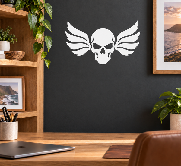 White skull with raven wings vinyl wall decal on dark surface