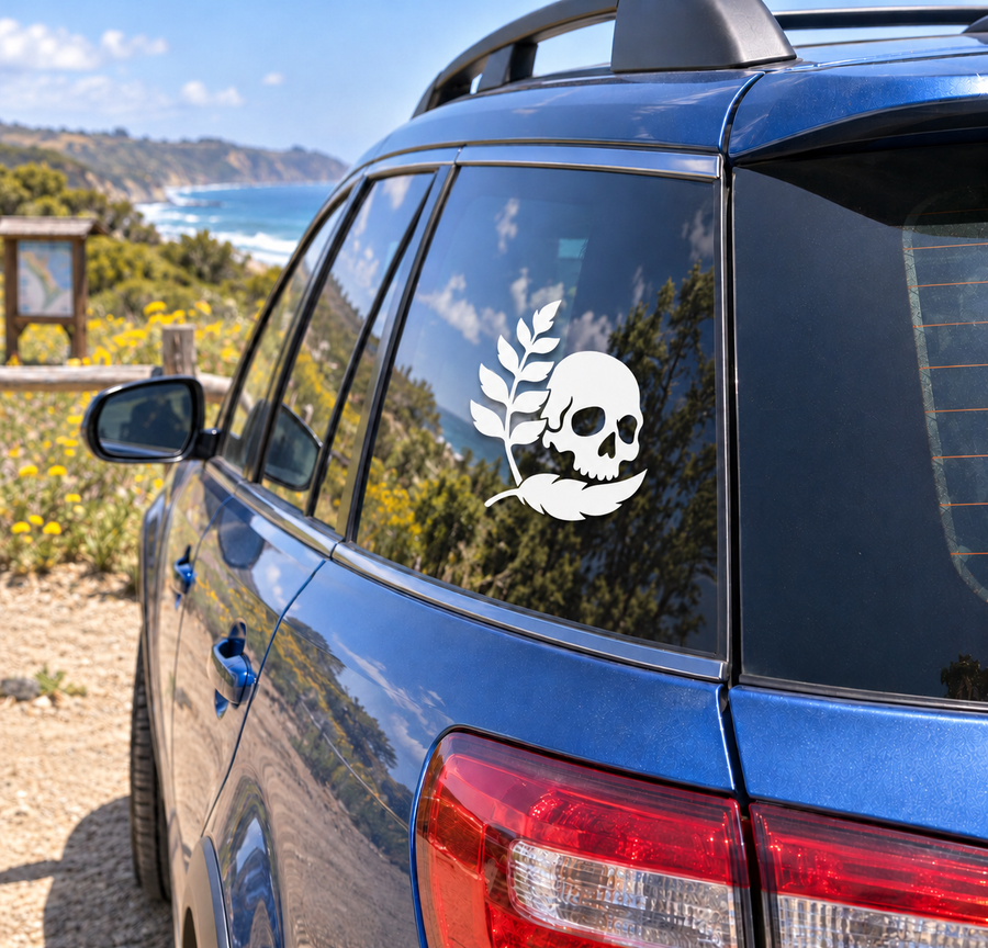 Skull and leaf plume vinyl decal for vehicle window, white design on dark glass