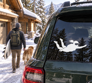 White skydiver vinyl decal on car rear window, helmeted silhouette with outstretched arms