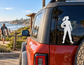 Skydiving vinyl decal of a person holding a helmet, shown on a car window