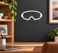 Vinyl decal of skydiving open goggles outline, white with black border