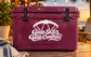 White parachute and "Good Skies Good Company" vinyl decal on purple suitcase
