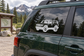 Truck vinyl decal graphic on dark green vehicle side window, front three-quarter view