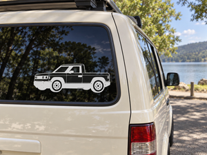 Truck vinyl decal on a car window, black-and-white side profile view.