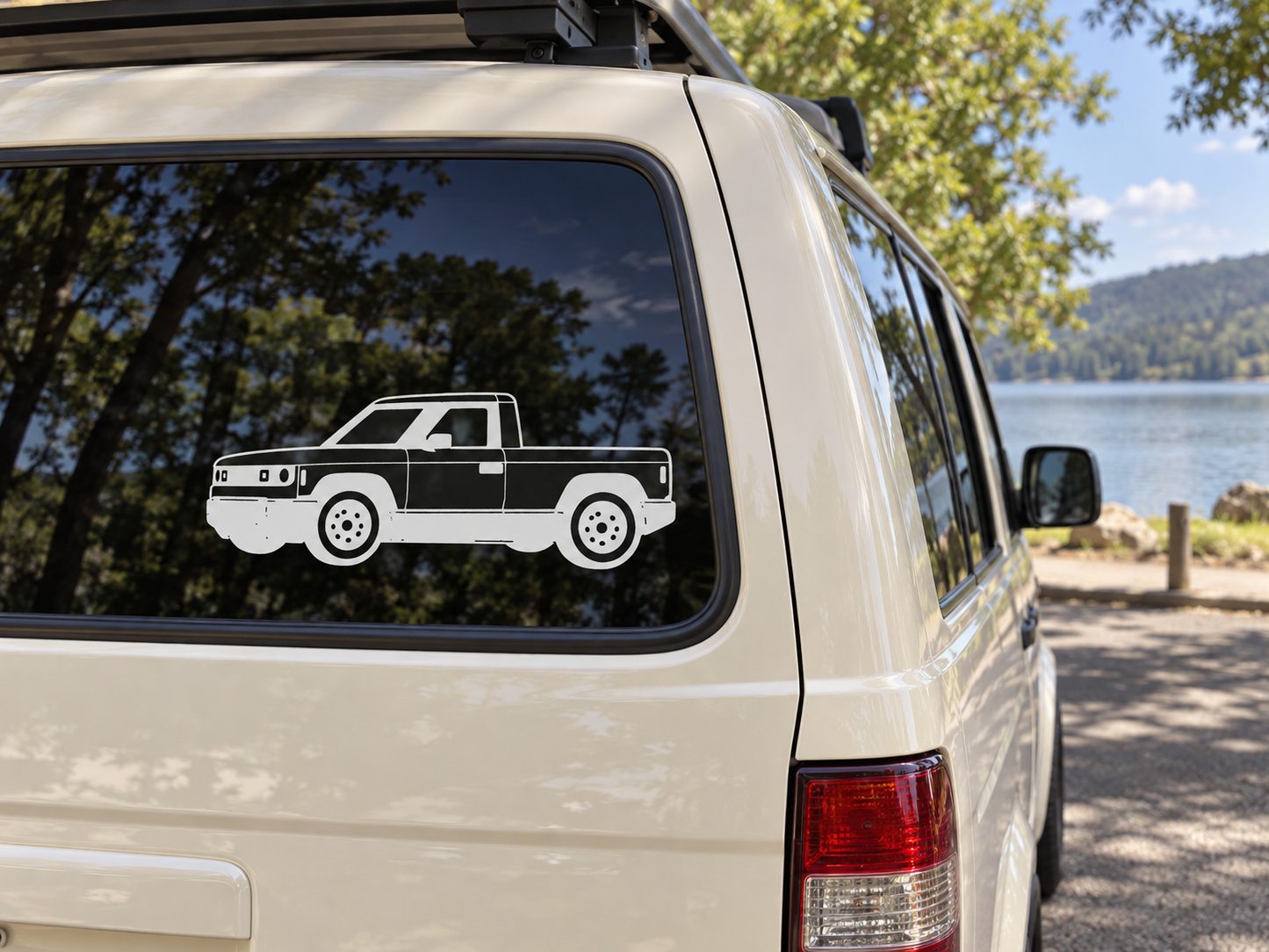 Truck vinyl decal on a car window, black-and-white side profile view.