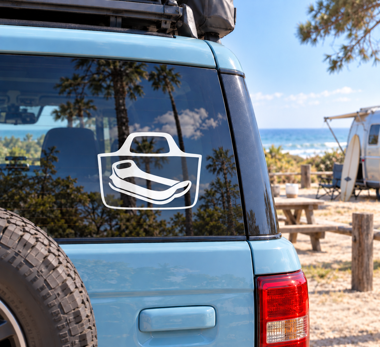 White vinyl tote decal with sledding graphic on vehicle window