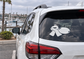 Sledding vinyl decal on car rear window, white sled and skates design
