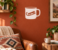 Vinyl mug decal with sled icon, white graphic on dark orange wall