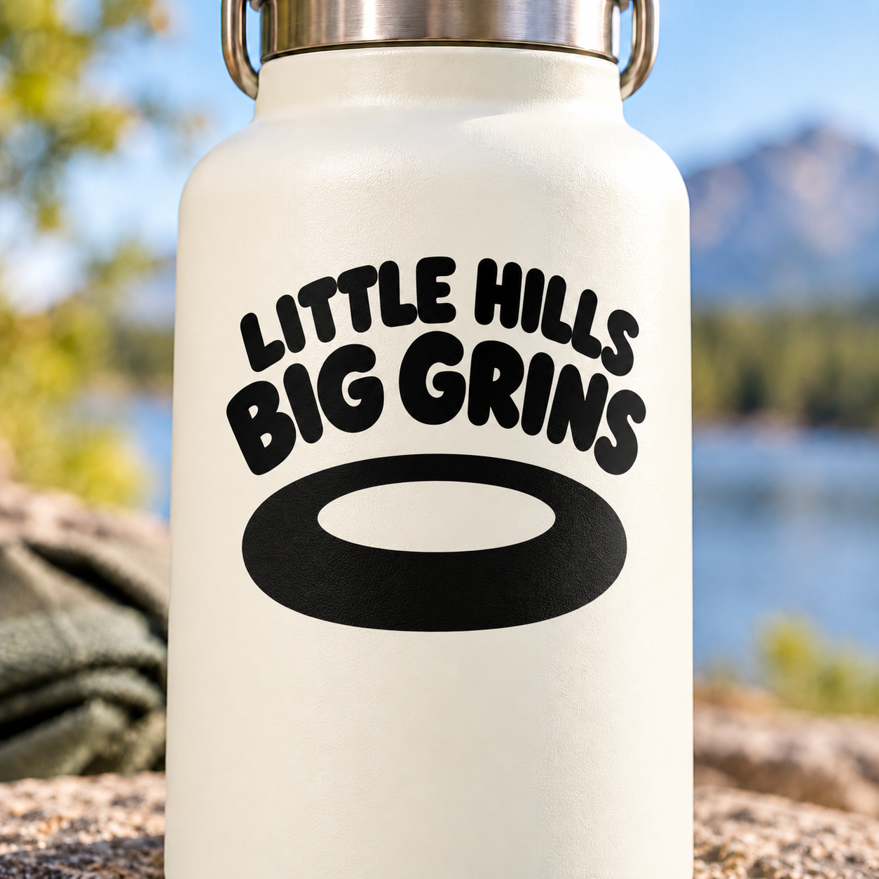 Vinyl decal with 'LITTLE HILLS BIG GRINS' text and oval graphic, black on light surface