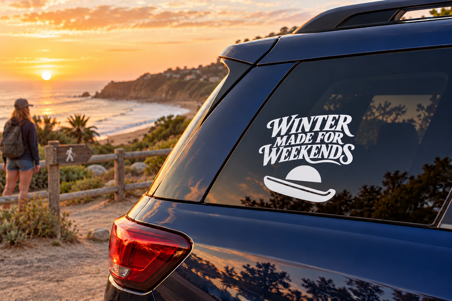 Vinyl window decal with "WINTER MADE FOR WEEKENDS" text and sled icon