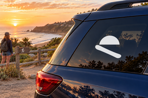 White sunrise-style vinyl decal with diagonal swoosh on car rear window