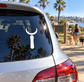Vinyl decal on car rear window: white crescent moon with vertical symbol
