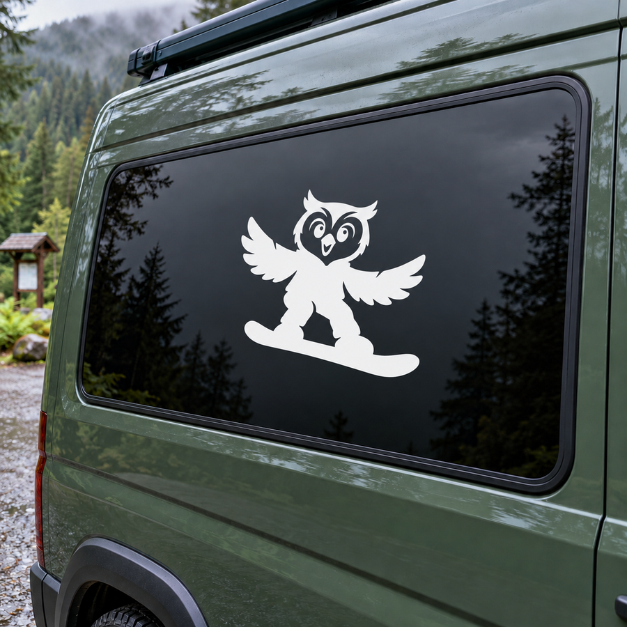 Vinyl owl snowboarding decal with white silhouette on dark vehicle window