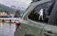 White vinyl soccer player decal holding a soccer ball on a car window.
