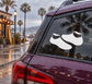 Vinyl decal of a pair of white soccer boots on a car window