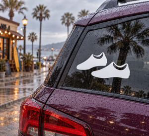 Pair of cleat vinyl decals with two white shoe icons on a car window